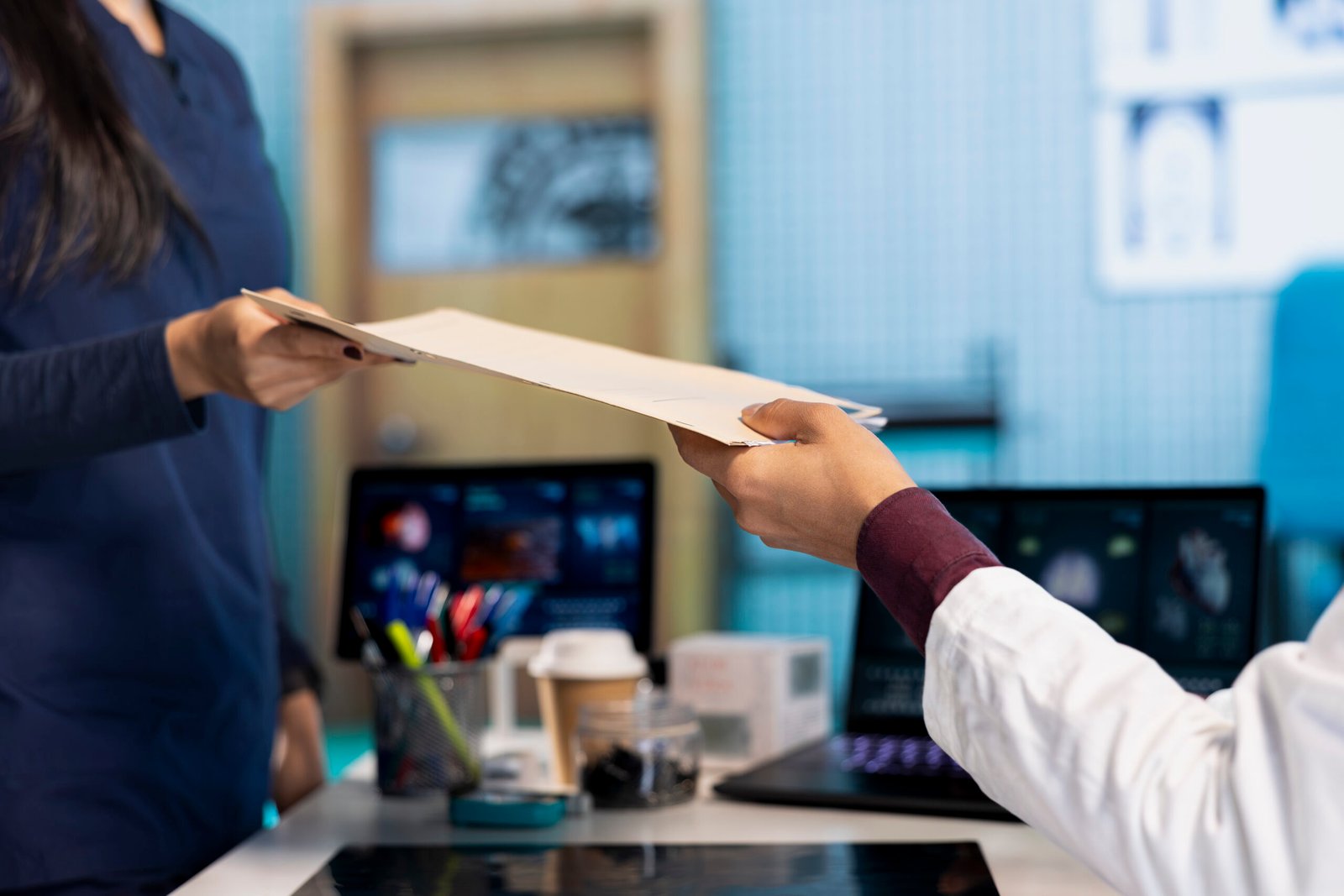 Indian healthcare professional sharing medical expertise with a patient in office, examining x ray and MRI scans results and focusing on disease recovery. Diagnostic report in a meeting.